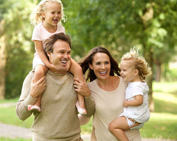 Familie fericita, mama, tata si doi copii se plimba in natura